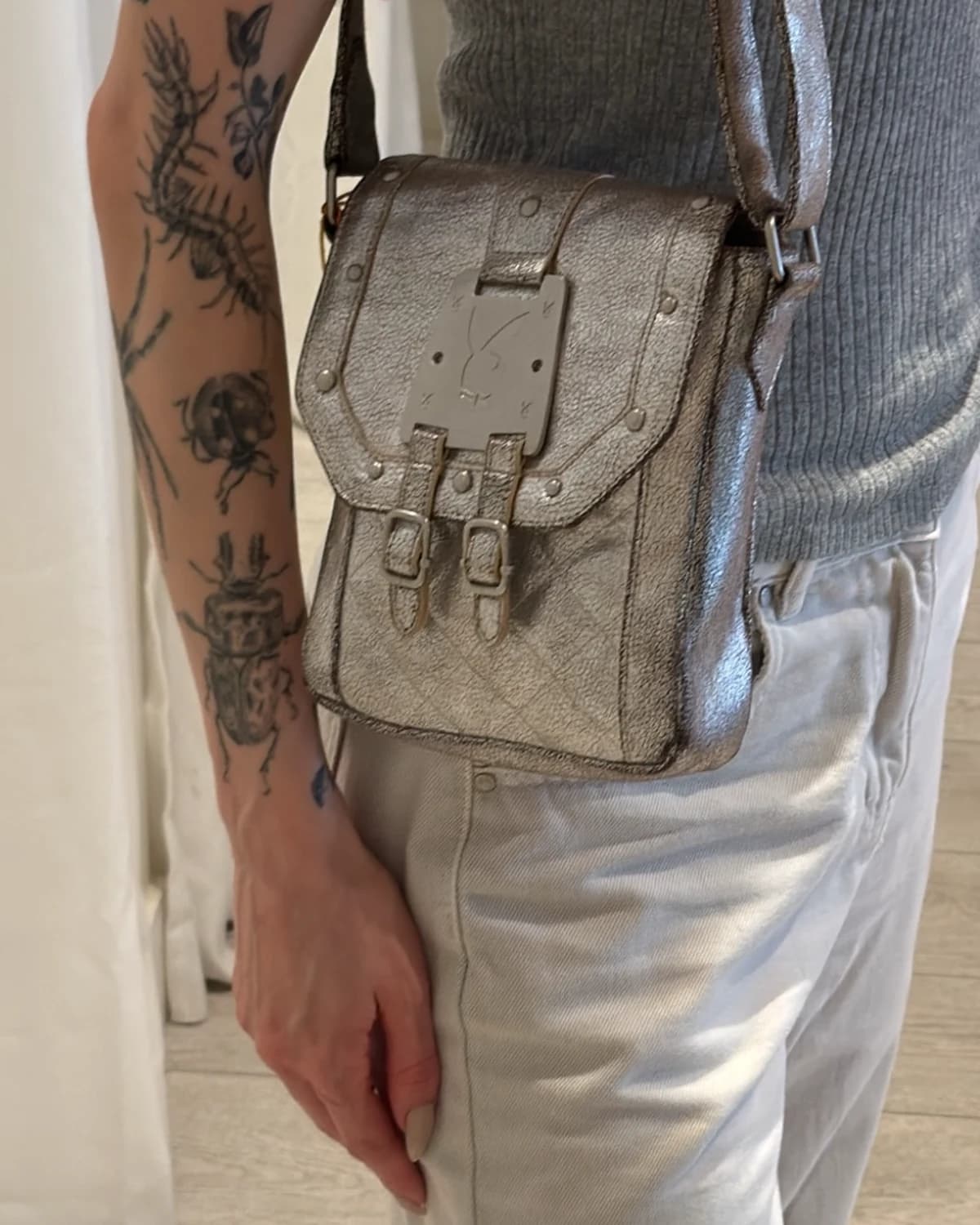 Silver Playboy crossbody bag worn by a model